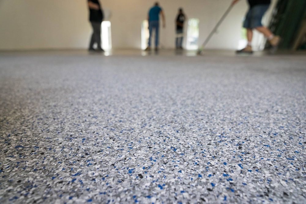 Low angle view across a freshly coated blue and gray flake floor